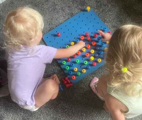 Children learning and playing with pegboards