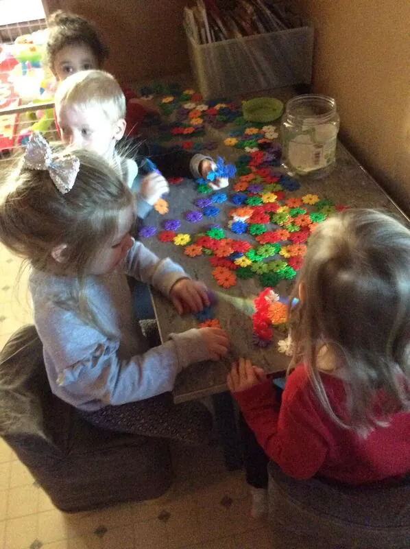 Two children playing with building toys, play time is learning time